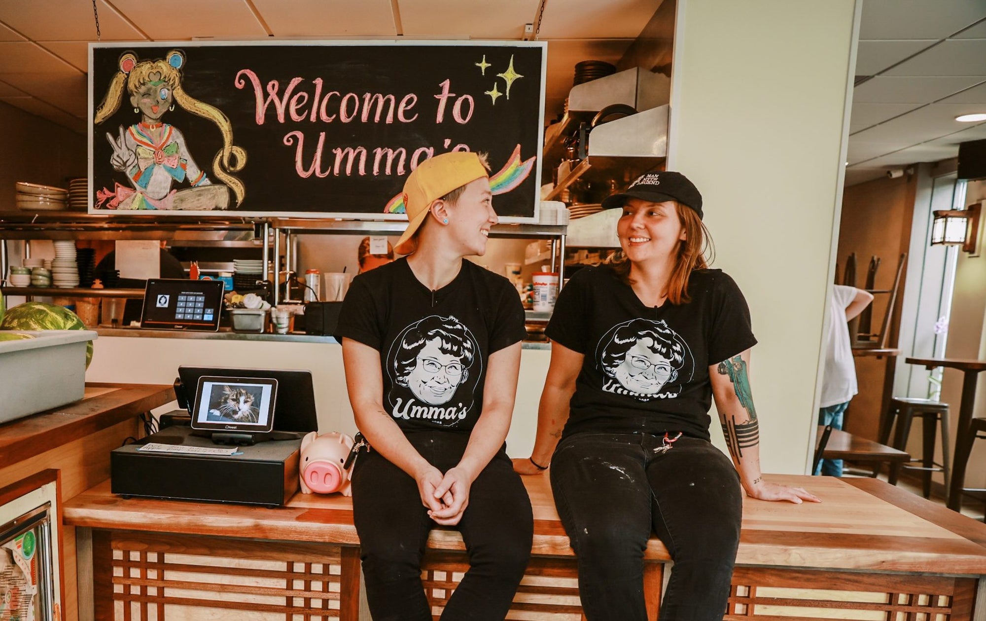 Portrait of Anna Gardner, chef and owner at Umma's, sitting in restaurant register with partner Kelsey Naylor