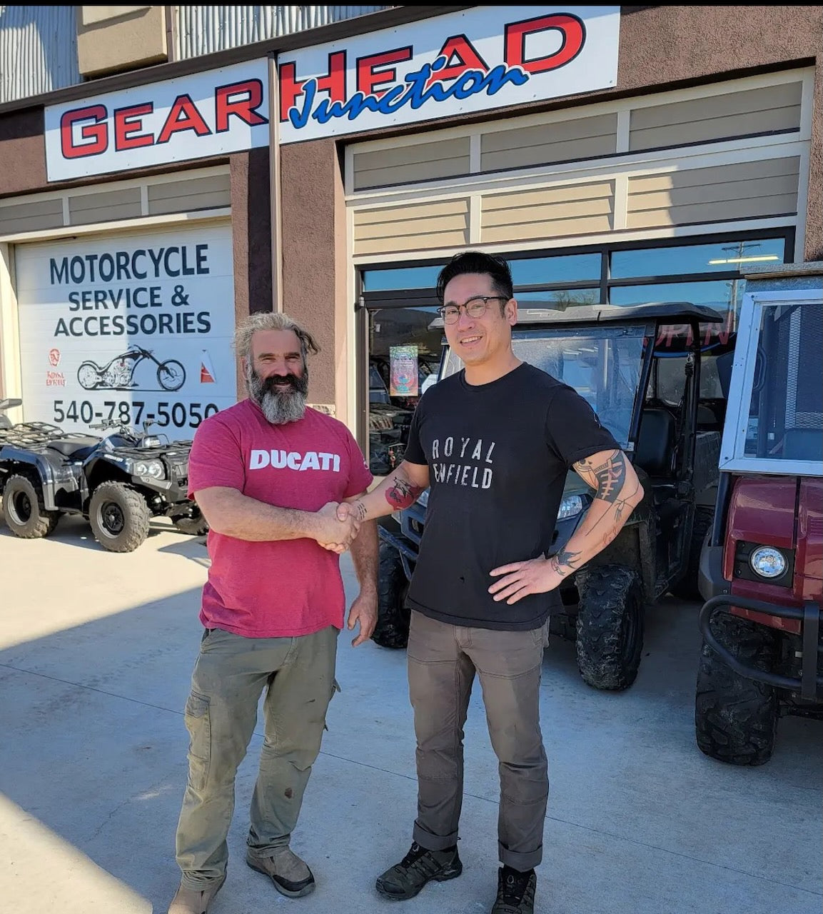 Candid of Terry Rafferty, owner of Geared Junction shaking hands with Vu in front of store