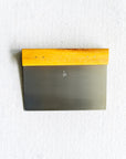 Metal bench scraper  with wooden handle on a white background