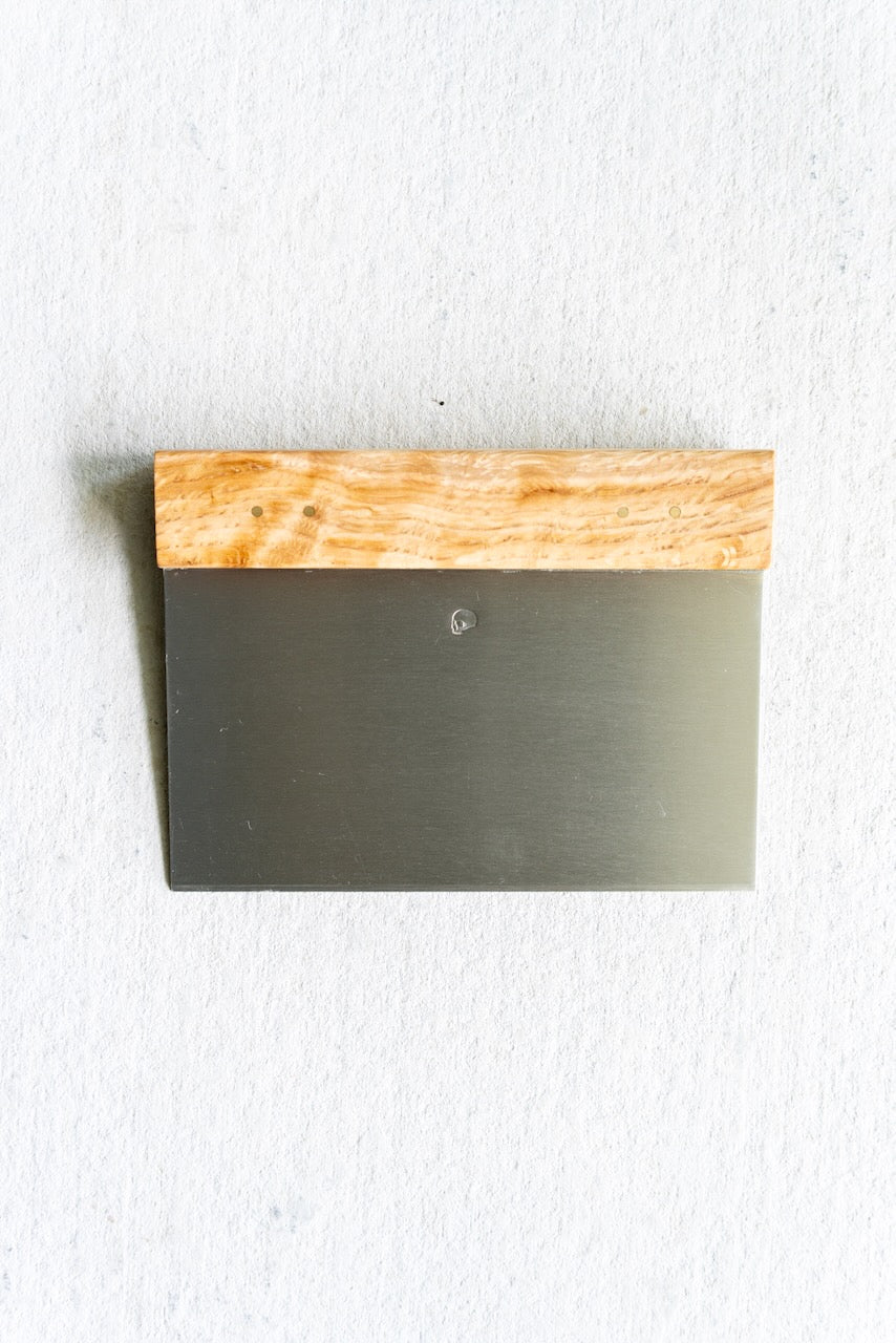 Metal tool with wooden handle on a white background