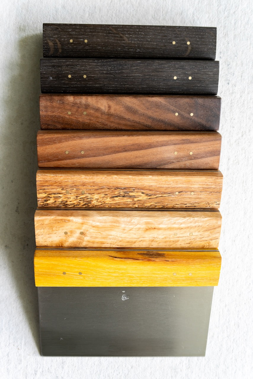 Stack of wooden blocks with different finishes on a white background