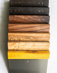 Stack of wooden blocks with different finishes on a white background